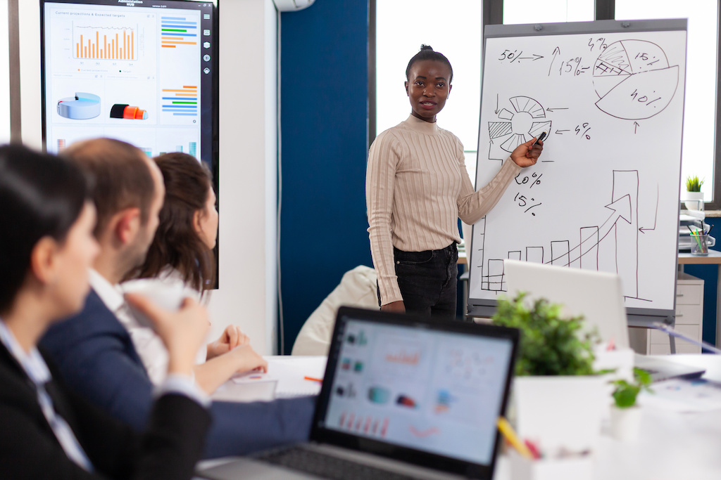 African american manager giving tasks for businesspeople